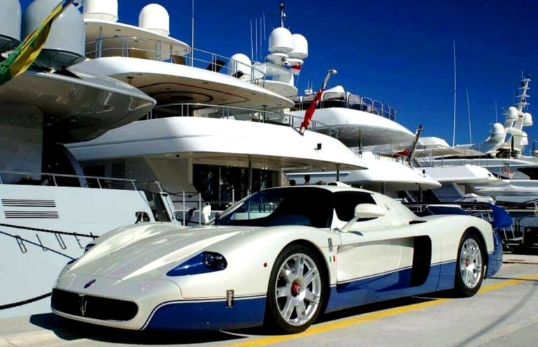 White sports car with black details, parked on a racetrack.